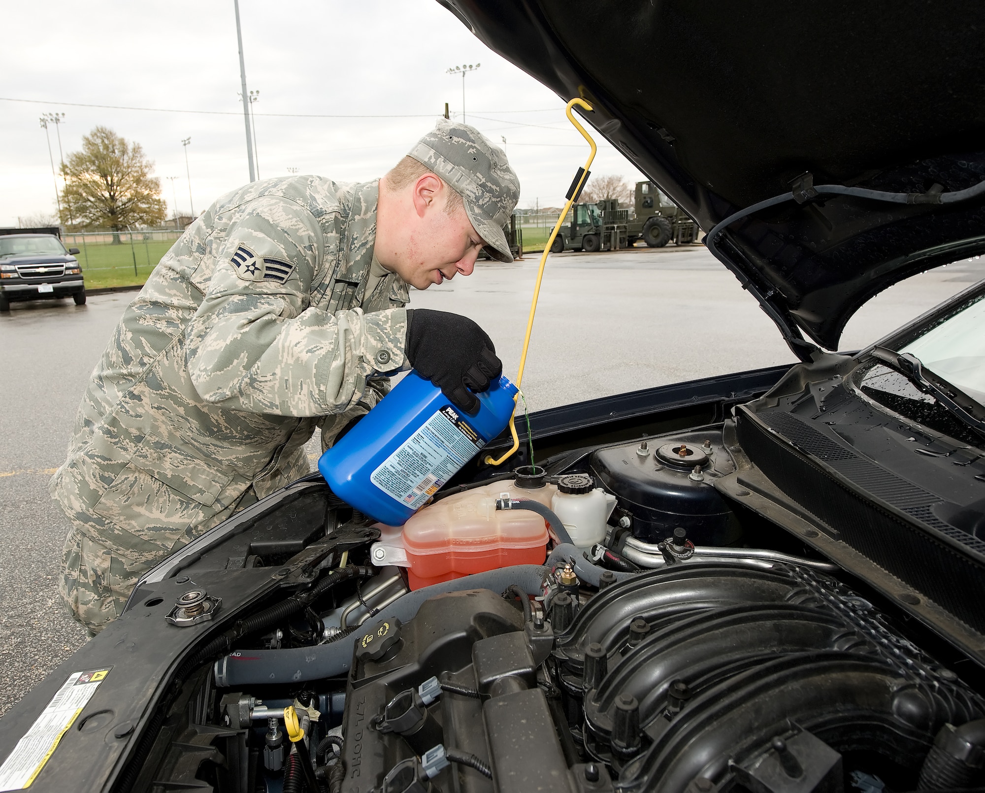 Senior Airman Jason Biehl, 436th Logistics Readiness Squadron assistant NCOIC of equipment support, refills the anti-freeze in a government vehicle.  To prepare for winter, the National Security Council recommends checking antifreeze levels, making sure the battery is charged and checking the treads of the tires for any damage or bald spots.  (U.S. Air Force photo/Jason Minto)