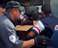 Army Specialist Kelly Carroll, Joint Task Force-Bravo crew chief, helps load supplies onto a Blackhawk helicopter in Costa Rica Dec. 1. More than 60 servicemembers, five Blackhawks and two Chanuks helped participate in humanitarian disaster relief in Costa Rica and Panama. (U.S. Air Force photo by Staff Sgt. Joel Mease)