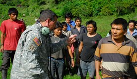 Army Staff Sgt. Colon, Joint Task Force-Bravo, translates instructions to locals in a remote village in Costa Rica. Each village received food, supplies and blankets. (U.S. Air Force photo by Staff Sgt. Joel Mease)