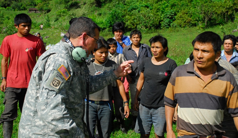 Army Staff Sgt. Colon, Joint Task Force-Bravo, translates instructions to locals in a remote village in Costa Rica. Each village received food, supplies and blankets. (U.S. Air Force photo by Staff Sgt. Joel Mease)