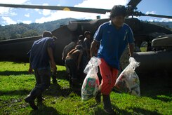 A person from a remote village in Costa Rica carry back food and supplies delivered by Joint Task Force-Bravo Dec. 1. (U.S. Air Force photo by Staff Sgt. Joel Mease)