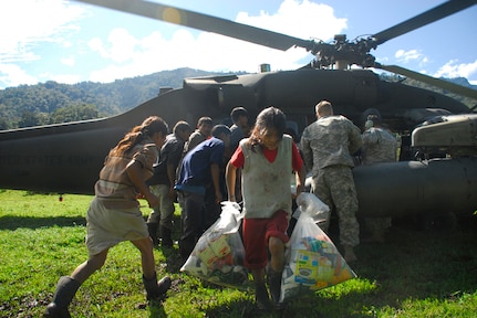 A child from a remote village in Costa Rica carries back food and supplies delivered by Joint Task Force-Bravo Dec. 1. The remote villages are inaccessable by vehicle and can take up to three days by foot to reach. (U.S. Air Force photo by Staff Sgt. Joel Mease)