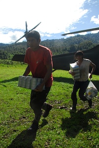 People from a remote village in Costa Rica carry back food and supplies delivered by Joint Task Force-Bravo Dec. 1. More than 150,000 pound had been delivered in Costa Rica and Panama by Nov. 30. (U.S. Air Force photo by Staff Sgt. Joel Mease)