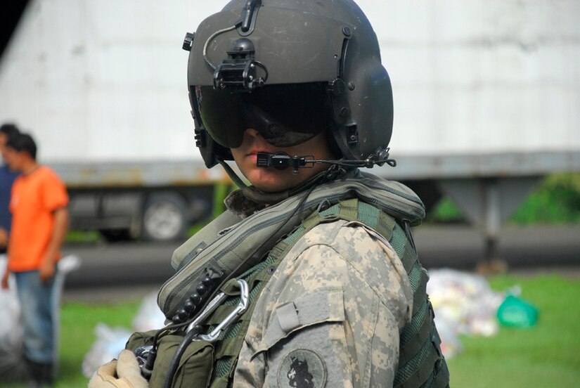 Army Sgt. Chris Jackson, Joint Task Force-Bravo crew chief, awaits instructions on the location of the next food drop Dec. 1.