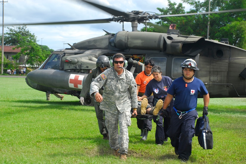 Army Staff Sgt. Jose Gutierrez and Specialist Robert Hunt carry an injured man from a medivac helicopter Dec. 1. More than 60 JTF-Bravo personnel participated in humanitarian disaster relief missions in Costa Rica and Panama. (U.S. Air Force photo by Staff Sgt. Joel Mease)