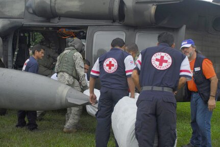 Members from the Costa Rica Red Cross load blankets onto a Blackhawk helicopter Nov. 30. Food and supplies were loaded onto the helicopters from staging points then delivered to remote villages in Costa Rica. (U.S. Air Force photo by Staff Sgt. Joel Mease)