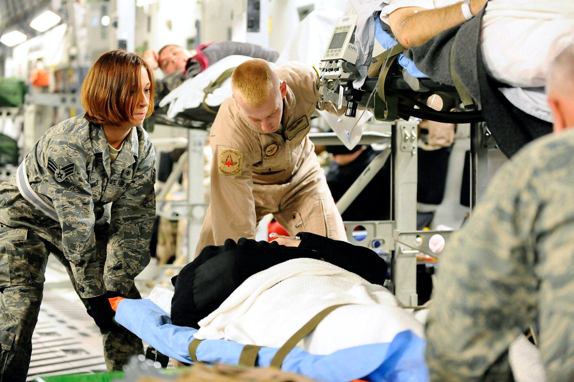 Senior Airman Samantha Brunner helps rack a patient onto a C-17 Globemaster Nov. 27 at Joint Base Balad, Iraq. Litter-bound patients are carefully secured onto the aircraft before flight. Airman Brunner, an aerospace medical service journeyman with the 332nd Expeditionary Aerospace Medical Squadron and native of Washington, Pa., is deployed from the 911th Airlift Wing at Pittsburgh International Airport Air Reserve Station, Pa. (U.S. Air Force photo/Airman 1st Class Jason Epley) 
