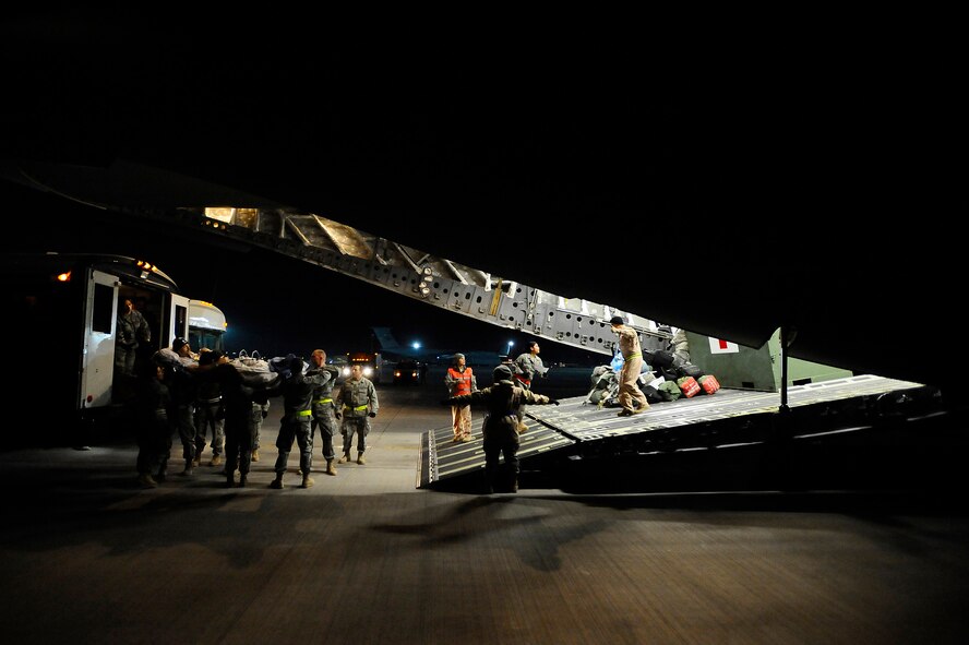 Senior Airman Samantha Brunner helps lower a patient from the ambulance bus to volunteers and medical staff Nov. 27 at Joint Base Balad, Iraq. Litter-bound patients and critical care air transport patients are carefully loaded onto aircraft before being aeromedically evacuated out of Iraq. In 2008, more than 7,500 patients have been transported from the CASF in 650 missions. Airman Brunner, an aerospace medical service journeyman with the 332nd Expeditionary Aerospace Medical Squadron and native of Washington, Pa., is deployed from the 911th Airlift Wing at Pittsburgh International Airport Air Reserve Station, Pa. (U.S. Air Force photo/Airman 1st Class Jason Epley) 
