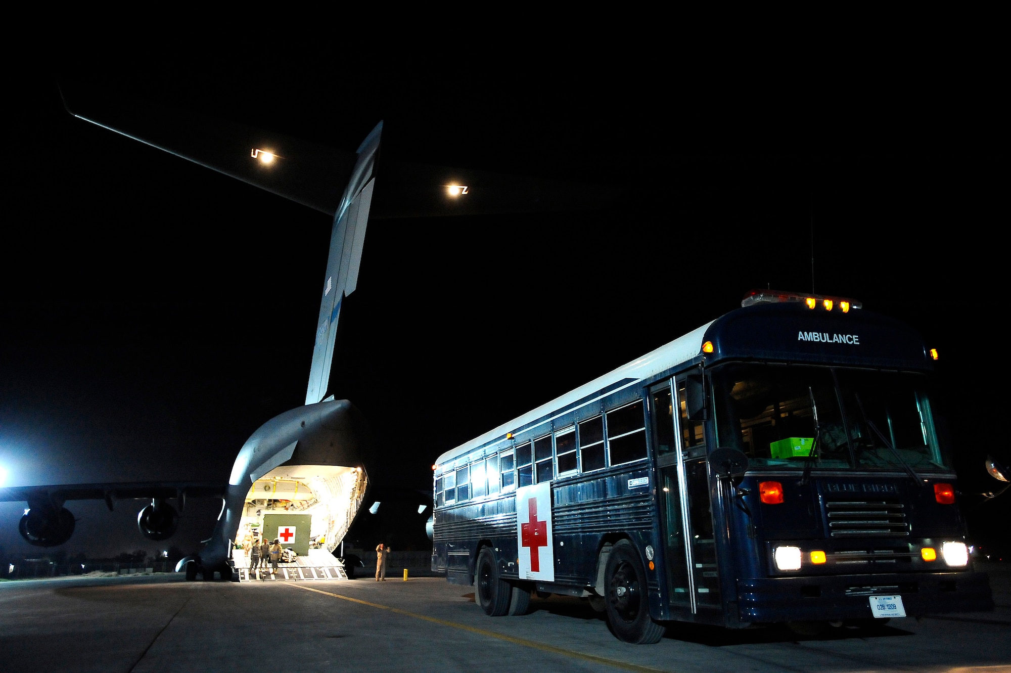 An ambulance bus from the Contingency Aeromedical Staging Facility prepares to unload ambulatory and litter-bound patients onto a C-17 Globemaster III Nov. 27 at Joint Base Balad, Iraq. In 2008, more than 7,500 patients have been transported from the CASF in 650 missions. (U.S. Air Force photo/Airman 1st Class Jason Epley) 
