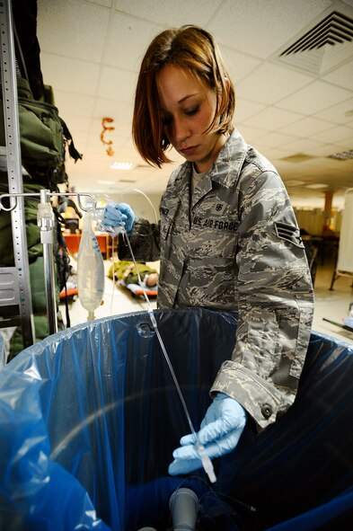 Senior Airman Samantha Brunner flushes air out of intravenous tubing Nov. 27 at the Contingency Aeromedical Staging Facility on Joint Base Balad, Iraq. Occlusions, or air bubbles, can enter a patient's vein and cause cardiac arrest. Airman Brunner, an aerospace medical service journeyman with the 332nd Expeditionary Aerospace Medical Squadron and native of Washington, Pa., is deployed from the 911th Airlift Wing at Pittsburgh International Airport Air Reserve Station, Pa. Her hometown is Washington, Pa. (U.S. Air Force photo/Airman 1st Class Jason Epley) 
