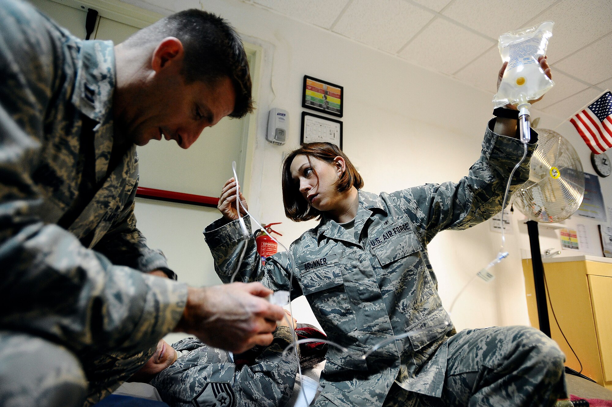 Capt. John Davis troubleshoots an intravenous pump as Senior Airman Samantha Brunner inspects the IV pump's port for any kind of blockage Nov. 27 at the Contingency Aeromedical Staging Facility on Joint Base Balad, Iraq. Both Airmen were preparing patients for an aeromedical evacuation flight. Airman Brunner, an aerospace medical service journeyman with the 332nd Expeditionary Aerospace Medical Squadron and native of Washington, Pa., is deployed from the 911th Airlift Wing at Pittsburgh International Airport Air Reserve Station, Pa. Captain Davis, a clinical nurse with the 332nd Expeditionary Aerospace Medical Squadron and native of Satellite Beach, Fla., is deployed from Patrick Air Force Base, Fla. (U.S. Air Force photo/Airman 1st Class Jason Epley) 
