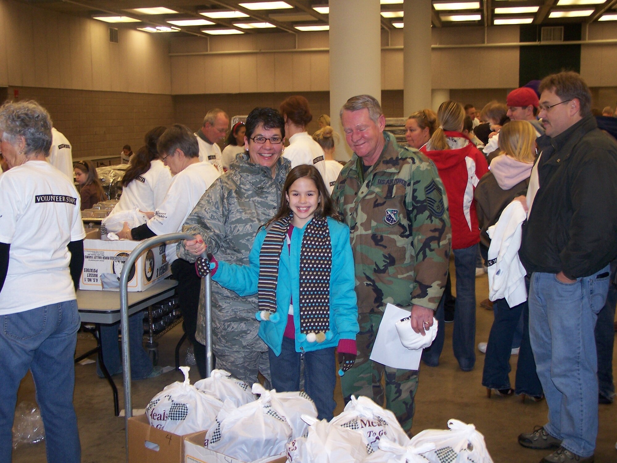 U.S. Air Force Senior Master Sgt. Shelly West and Chief Master Sgt. Jeff West, both 148th Fighter Wing members, along with their daughter volunteer to make deliveries of Thanksgiving meals Nov. 27, 2008 to local community members in Duluth, Minn.  The College of St. Scholastica sponsors a Thanksgiving Buffet for community members each year at the Duluth Entertainment and Convention Center along with home deliveries for people that can not make it to the event.  (U.S. Air Force photo by Capt. Audra Flanagan)