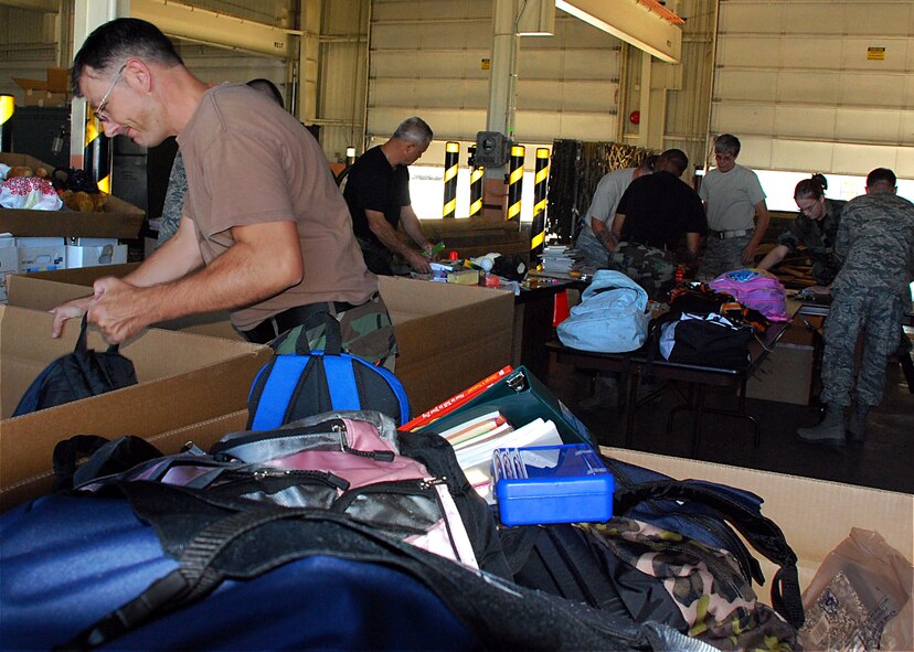 301st Civil Engineer Squadron members volunteered their time and effort to organize donations for Operation Care. Operation Care is a charity organization that benefits displaced refugees and Provisional Reconstruction Teams (PRT) Afhgan members in the Afghanistan war zone. Lt. Col. Chris Yancy, 301st Operations Group deputy commander and Operation Care project officer, helped collect close to 20 thousand pounds of donation items this year alone. (U.S. Air Force Photo/Tech. Sgt. Julie Briden-Garcia)