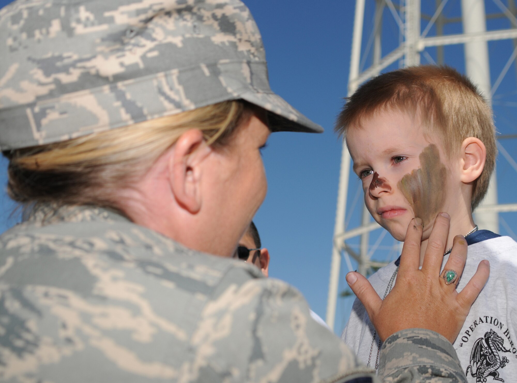 Sergeant Woodruff paints Russell Hawley’s face during April’s Operation Hero, a deployment familiarization program for children. His parents are Tech. Sgt. Laurence and Carrie Hawley, 81st Medical Operations Squadron.  (U.S. Air Force photo by Kemberly Groue)