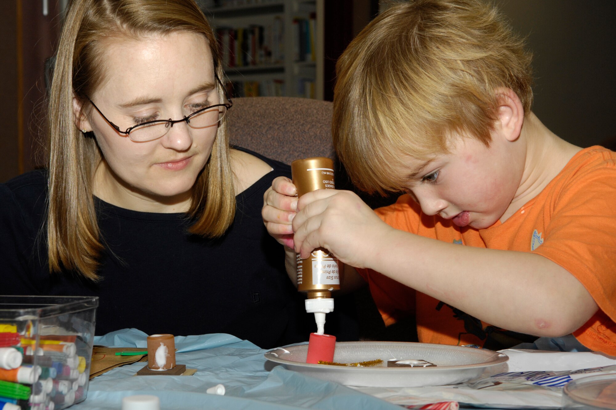 HANSCOM AIR FORCE BASE, Mass. – Ryan Long (right) adds a little more glue to his holiday craft creation at the Airman and Family Readiness Center on Dec. 1, as his mom, Jodi, looks on. The A&FRC sponsors a number of activities and classes for the Hanscom community. For more information on their programs, as well as other activities and events taking place at Hanscom go to www.hanscom.af.mil (U.S. Air Force photo by Linda LaBonte Britt)
