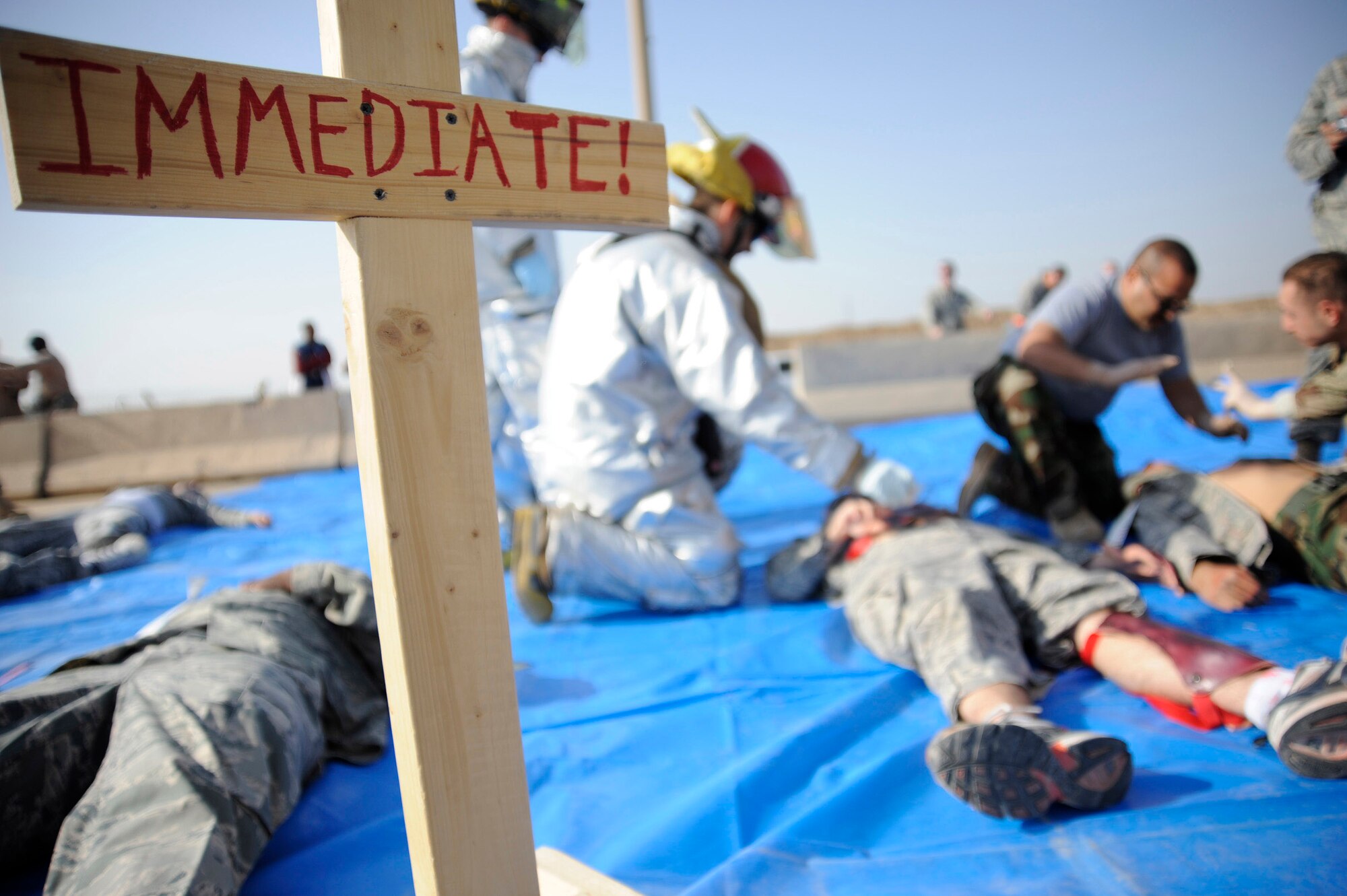 Iraqi and U.S. emergency response personnel attend to mock immediate care casualties during a major accident response exercise Nov. 21 at New Al-Muthana Air Base, Iraq. The exercise tests the abilities of a joint response of fire rescue, medical and security capabilities. (U.S. Air Force photo/Staff Sgt. Paul Villanueva II) 
