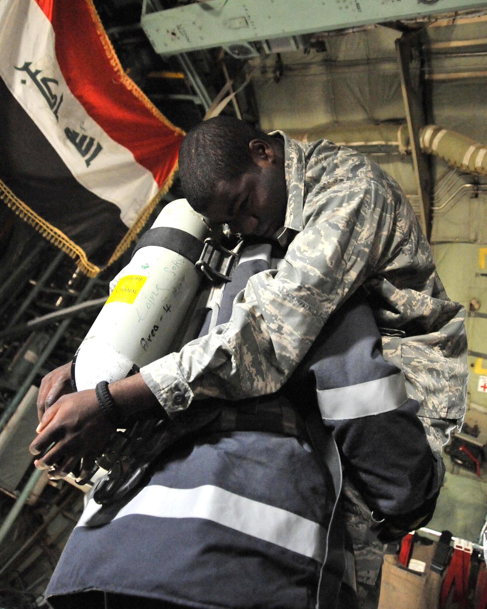 An Iraqi air force firefighter rescues a U.S. Airman mock casualty during a major accident response exercise Nov. 21 at New al Muthana Air Base, Iraq. The exercise tests the abilities of a joint response of fire rescue, medical and security capabilities. (U.S. Air Force photo/Master Sgt. Brian Davidson) 