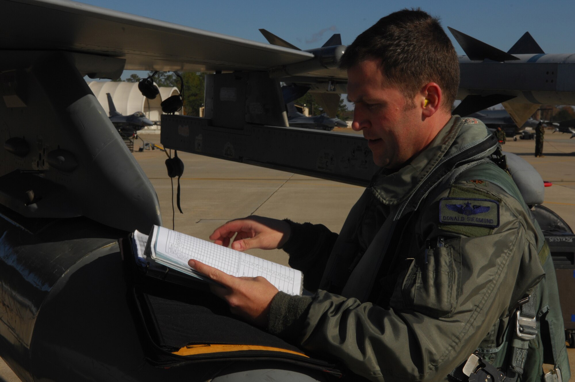 SHAW AIR FORCE BASE, SC -- Major Donald Siegmund, 77th Fighter Squadron pilot, does a pre-flight check on his F-16 Fighting Falcon jet on December 1, 2008. Major Siegmund along with other fighter pilots from the 77th Fighter Squadron, launched as part of a deployment. (U.S. Air Force photo/ Senior Airman Matthew Davis)