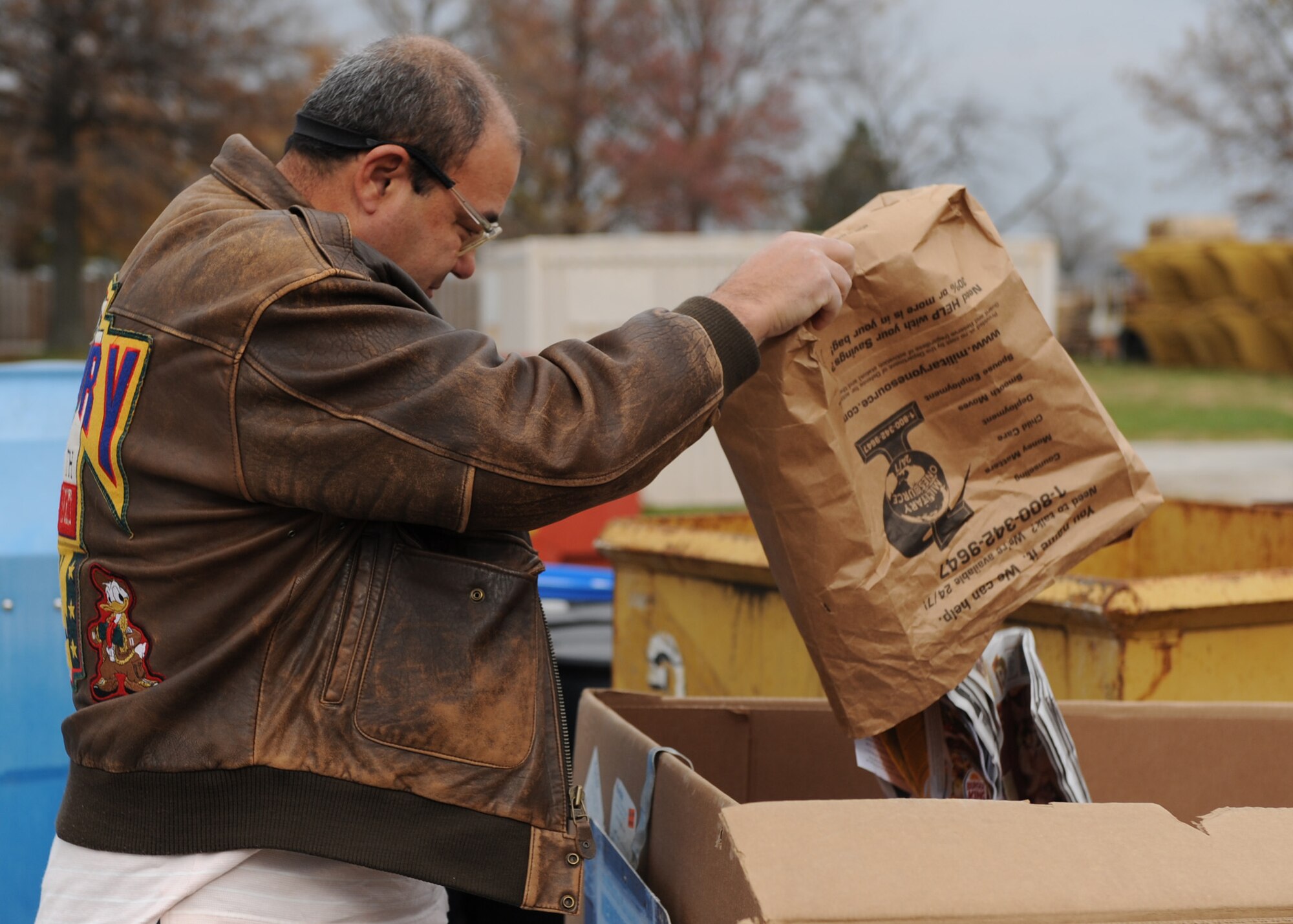 Lt. Col. (ret.) Mike Delpinto, places his recyclables at the customer service area. Mr. Delpinto makes use of the Scott Recycling Center because it is free.  (U.S. Air Force photo/Airman 1st Class Wesley Farnsworth)