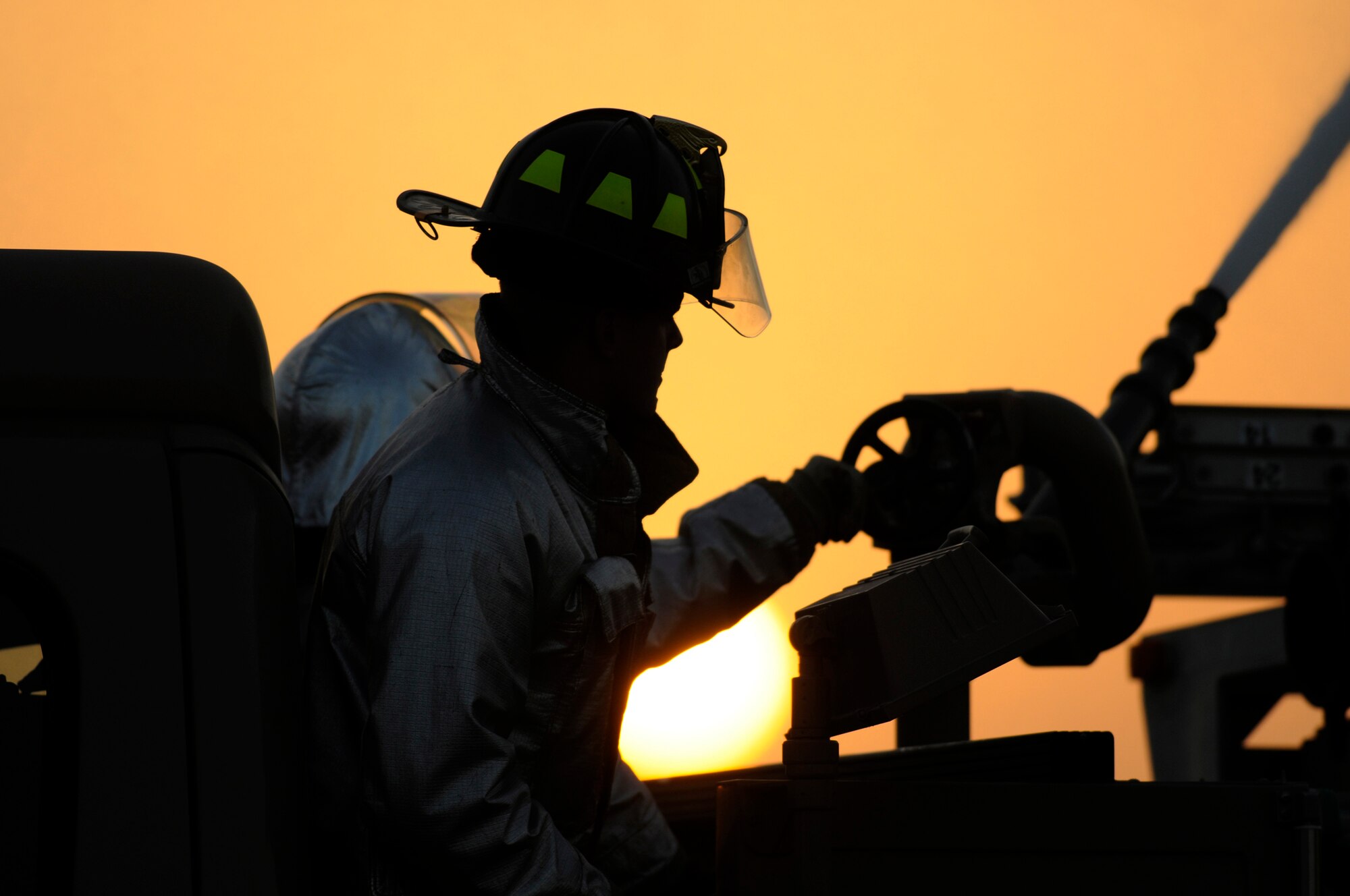 Senior Airman Chad Engman and Airman 1st Class Abe Barragnon, firefighters assigned to the 379th Expeditionary Civil Engineer Squadron, operate a water cannon Dec. 1, at an undisclosed air base in Southwest Asia.  The water cannon at full power will empty its water tank in one minute.  A daisy chain approach is used from a fire hydrant to a filler truck and finally into the truck which will fight the fire.  Airman Engman, a native of Cincinnati, Ohio, is deployed from Beale Air Force Base, Calif.  Airman Barragnon hails from Los Angeles, Calif., and is deployed from Travis AFB, Calif.  Both are deployed in support of Operations Iraqi and Enduring Freedom and Joint Task Force-Horn of Africa.  (U.S. Air Force photo by Tech. Sgt. Michael Boquette/Released)