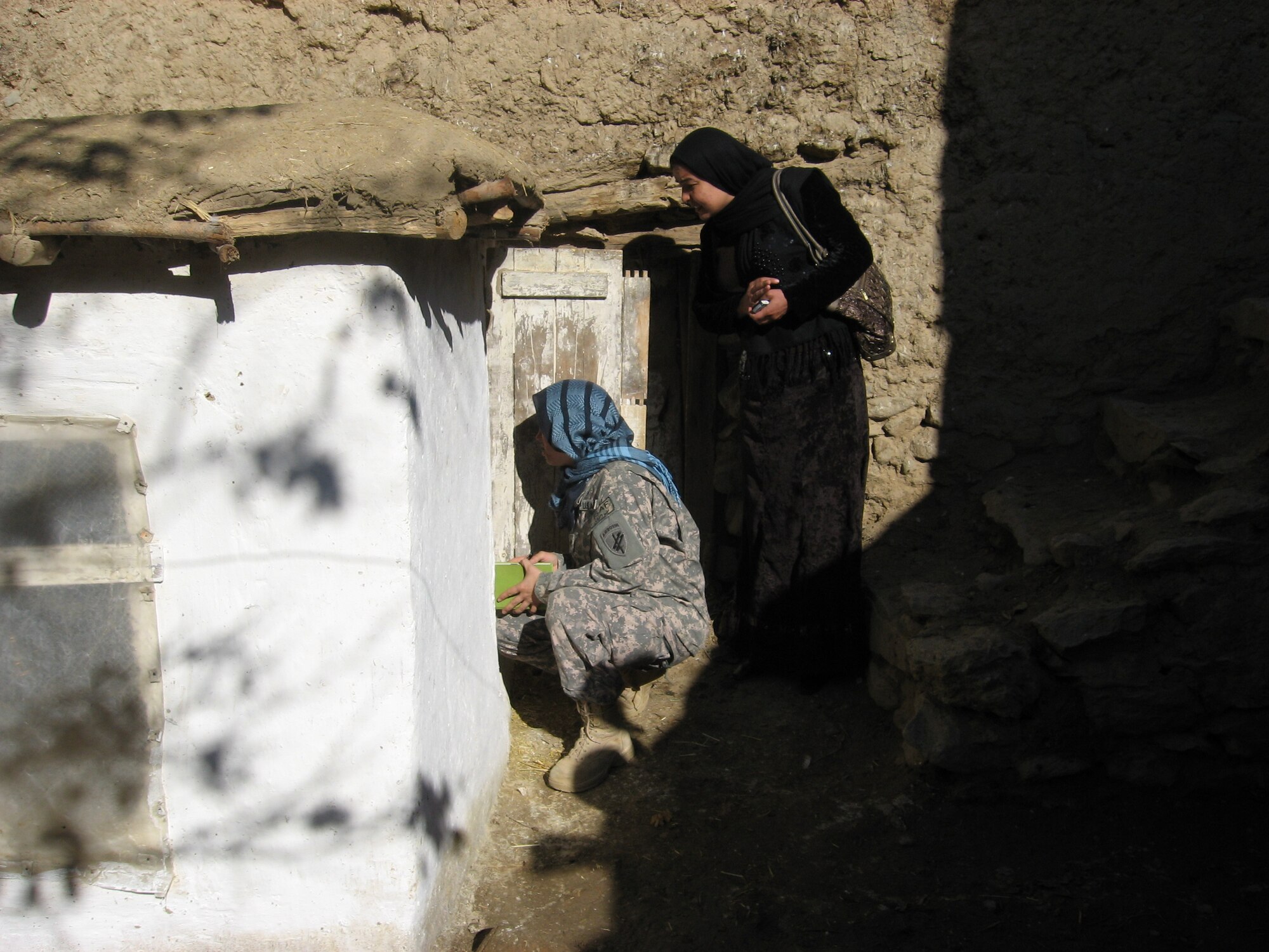 Brishna Yaftali, the Director of Marwa Cultural Development Organization, and a member of the Panjshir Provincial Reconstruction Team woman’s affairs team inspects a chicken coop in Tawakh village, Panjshir province, Afghanistan, Nov. 22.