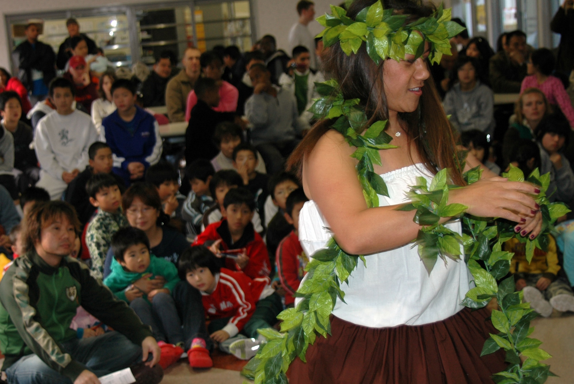 MISAWA AIR BASE, Japan -- Navy spouse Leata Cheng, a member of the Misawa Polynesian Dancers club, performs a dance for children from Bikoh-en orphanage in Shichinohe Mache, Japan Nov. 9, 2008. The day was designed as a kick-off for regular command-sponsored visits to the orphanage in the future. (U.S. Navy Photo by Chief Petty Officer Brian Naranjo)

