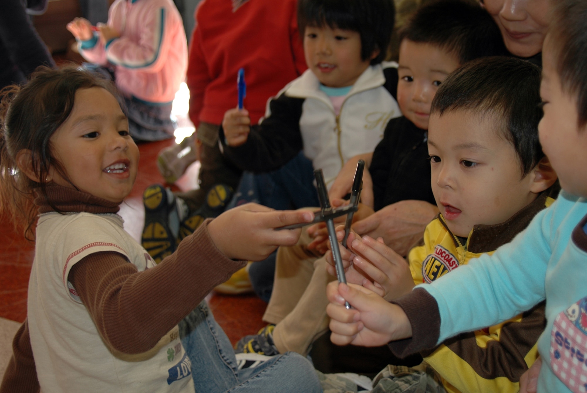 MISAWA AIR BASE, Japan -- Four-year-old Aiyani Marquez, step-daughter of Petty Officer 2nd Class Orlando Garcia, plays with children from Bikoh-en orphanage in Shichinohe Mache, Japan Nov. 9, 2008. Ms. Marquez came in support of a community relations visit to the orphanage, organized by Sailors from the Naval Air Facility Misawa. More than 75 military and family members attended the event, which featured gifts, dance performances, a cookout, and of course, playtime. (U.S. Navy Photo by Chief Petty Officer Brian Naranjo)
