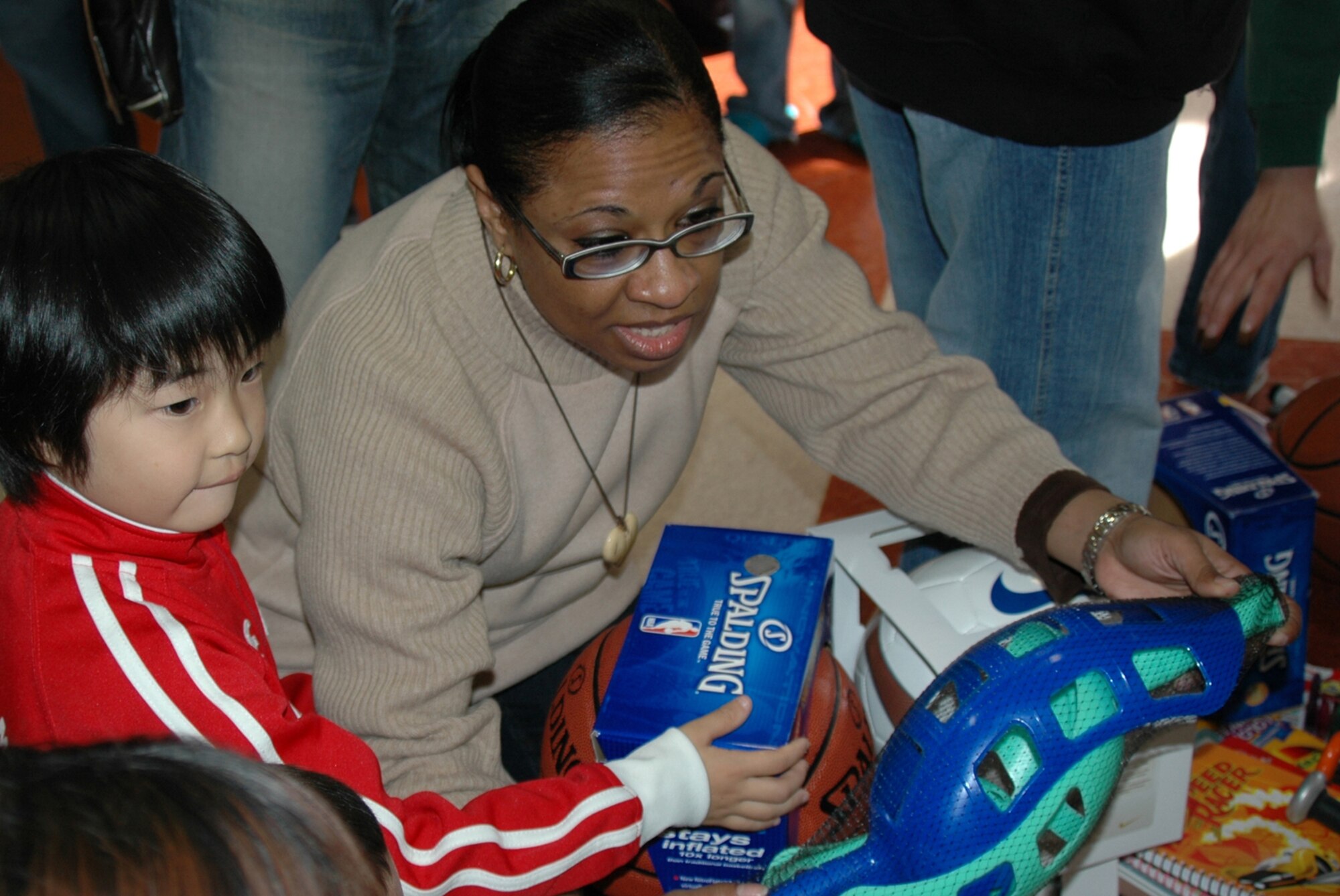 MISAWA AIR BASE, Japan -- Senior Chief Petty Officer Sharon Alexis, Naval Air Facility Misawa, hands out gifts to eager children at Bikoh-en orphanage in Shichinohe Mache, Japan Nov. 9, 2008. The gifts were donated in support of a community relations visit to the orphanage, organized by Sailors from the Naval Air Facility Misawa. (U.S. Navy Photo by Chief Petty Officer Brian Naranjo)
