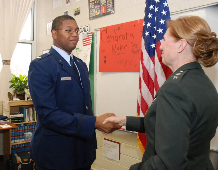 Retired Army Maj. Gen. Donna Barbisch congratulates newly promoted Major Andre Wright during his promotion ceremony at Walker Middle School in Cobb County on Dec. 1.  The promotion ceremony was hosted by Mrs. Kim Ragan's 7th grade class. General Barbisch gave the oath of office in absence of the 628th's senior officers who were deployed.  General Barbisch is also the mother of 1st Lt. Patricia Barbisch who is also assigned to the 628th Engineering Flight. (Air Force photo by Master Sgt. Stan Coleman) 