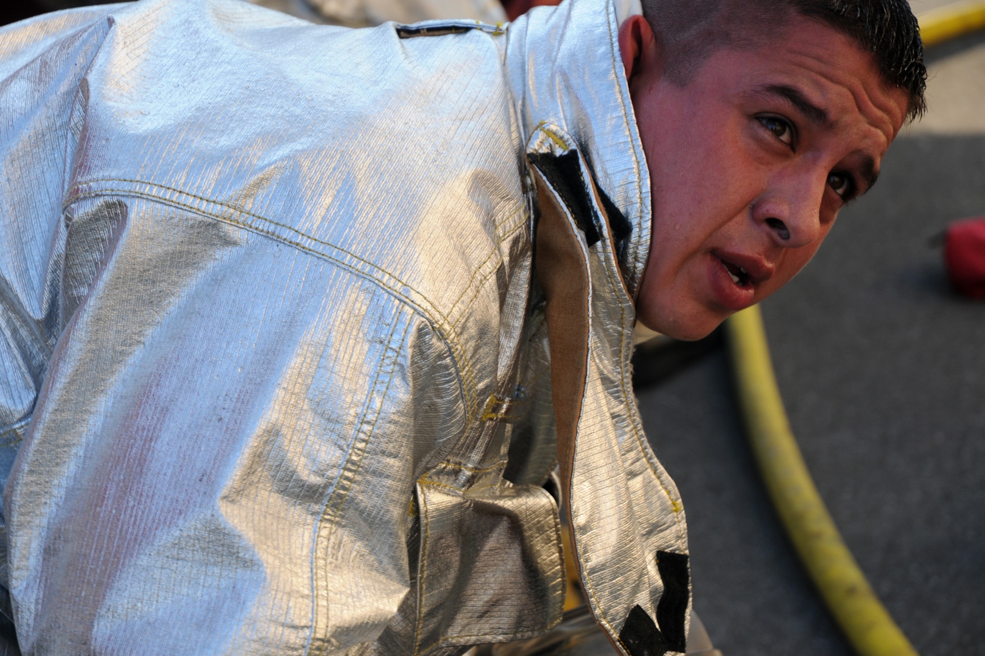 Staff Sgt. John Garcia, 18th Civil Engineering Squadron Fire Department, takes a breather after completing a simulated scenario involving a kitchen fire and saving two victims at the Silver Flag Training Facility Dec. 2 at Kadena Air Base. The 18th Wing is participating in a Local Operational Readiness Exercise to test the readiness of Kadena Airmen. (U.S. Air Force photo/Airman 1st Class Amanda Grabiec)