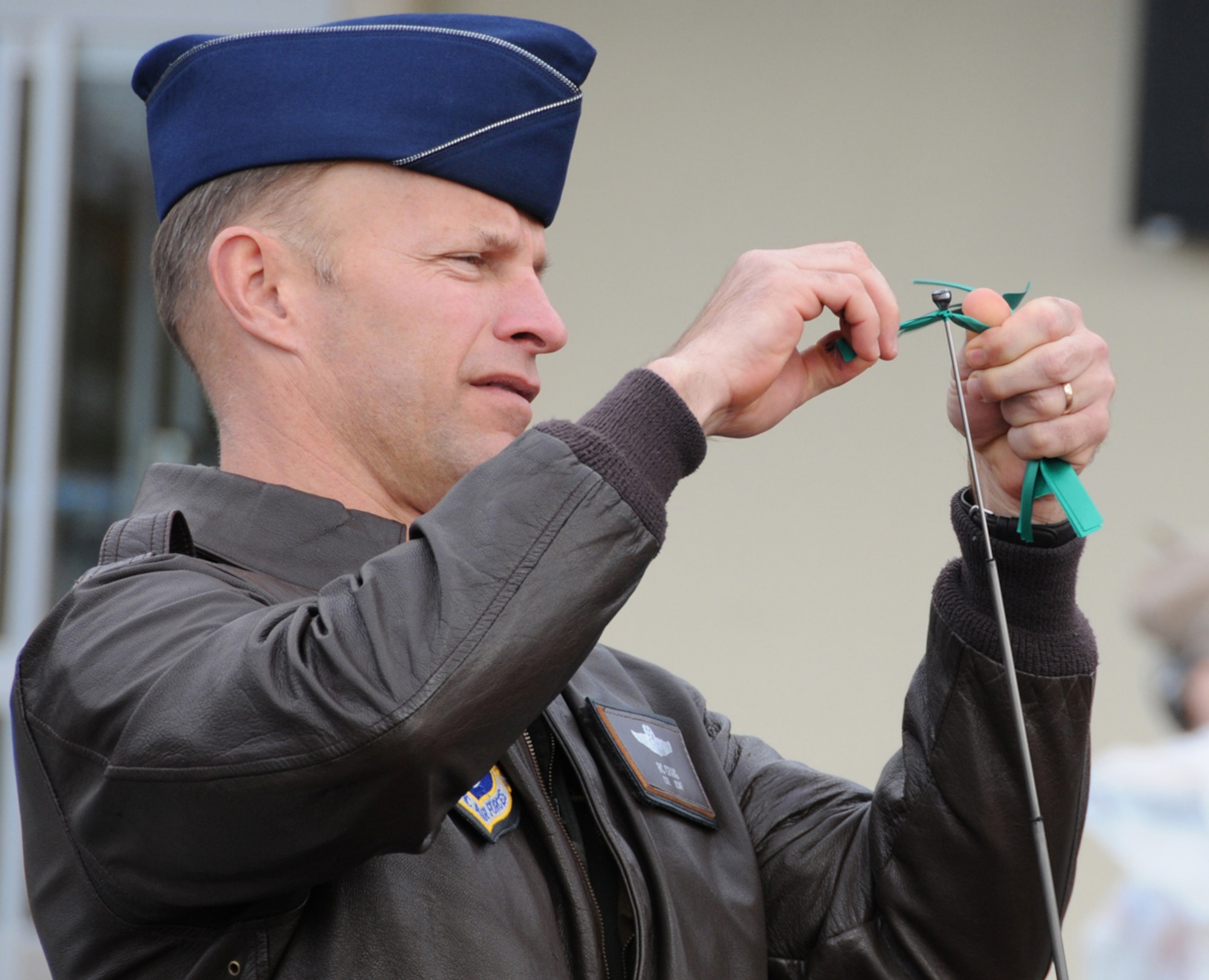 MISAWA AIR BASE, Japan -- Col. R.C. Craig, 35th Fighter Wing vice commander, ties a green ribbon on an Airman's antenna as part of the 14th Annual Green Ribbon Tie One On campaign Nov. 26, 2008. The ribbons serve as a visible reminder to Airmen to drink responsibly and have a plan instead of drinking and driving. (U.S. Air Force photo by Senior Airman Jamal D. Sutter)