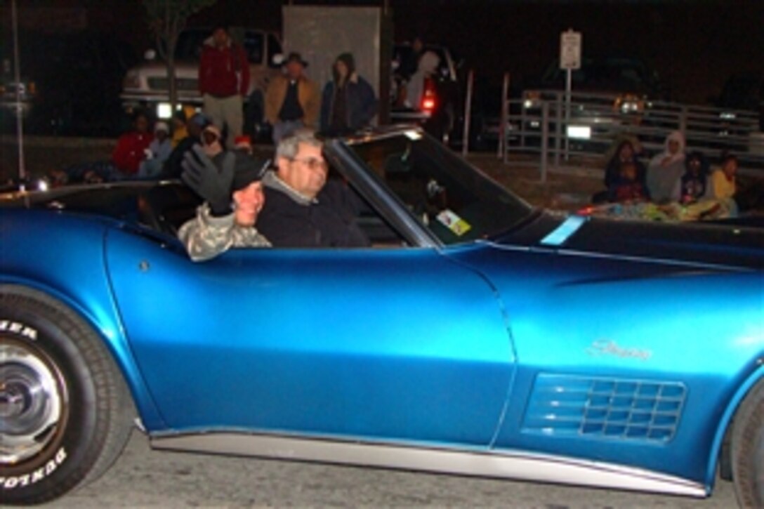 U.S. Army Sgt. Frank Bailey, assigned to the13th Expeditionary Sustainment Command, rides in a classic Chevy Corvette as a guest of the city of Temple, Texas, during its annual Christmas parade, Dec. 1, 2008. The 13th Expeditionary Sustainment Command is assigned to nearby Fort Hood, Texas.