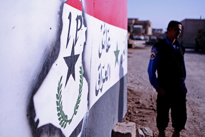 An Iraqi Policeman stands at the gate of the Huriyah Police District Headquarters in Ramadi, Iraq, Dec. 2. The chiefs of police of local Iraqi Police stations met at the headquarters to discuss operations within their areas of operation.