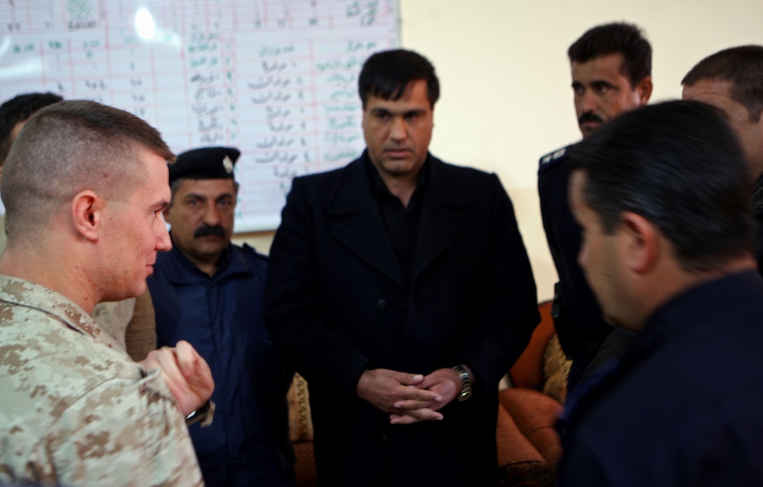Capt. Brian O’Shea, the commander for Company E, 2nd Battalion, 9th Marine Regiment, Regimental Combat Team 1, talks with Iraqi chiefs of police at the Huriyah Police District Headquarters in Ramadi, Iraq, Dec. 2.