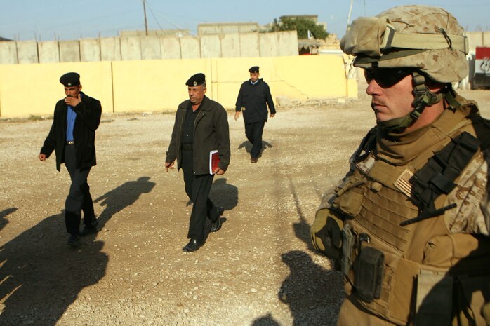 Cpl. William C. Price, a 22-year-old rifleman from Zaleski, Ohio, with Company E, 2nd Battalion, 9th Marine Regiment, Regimental Combat Team 1, stands security during a meeting at the Huriyah District Police Headquarters in Ramadi, Iraq, Dec. 2.