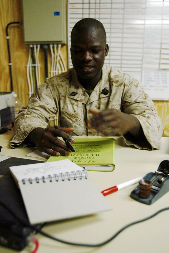 George Akwei Mingle, a Ghanaian-born corpsman with Task Force 3rd Battalion, 7th Marine Regiment, Regimental Combat Team 5, practices his architectural drawing at Combat Outpost Rawah, Iraq, Dec. 4 during his free time to keep his skills sharp as he begins his journey toward gaining his masters degree in architecture.  Mingle, who moved to Alexandria, Va. after finishing his bachelor's degree in Ghana, hopes to eventually become an officer in the Seabees and establish himself as an independent architect.::r::::n::