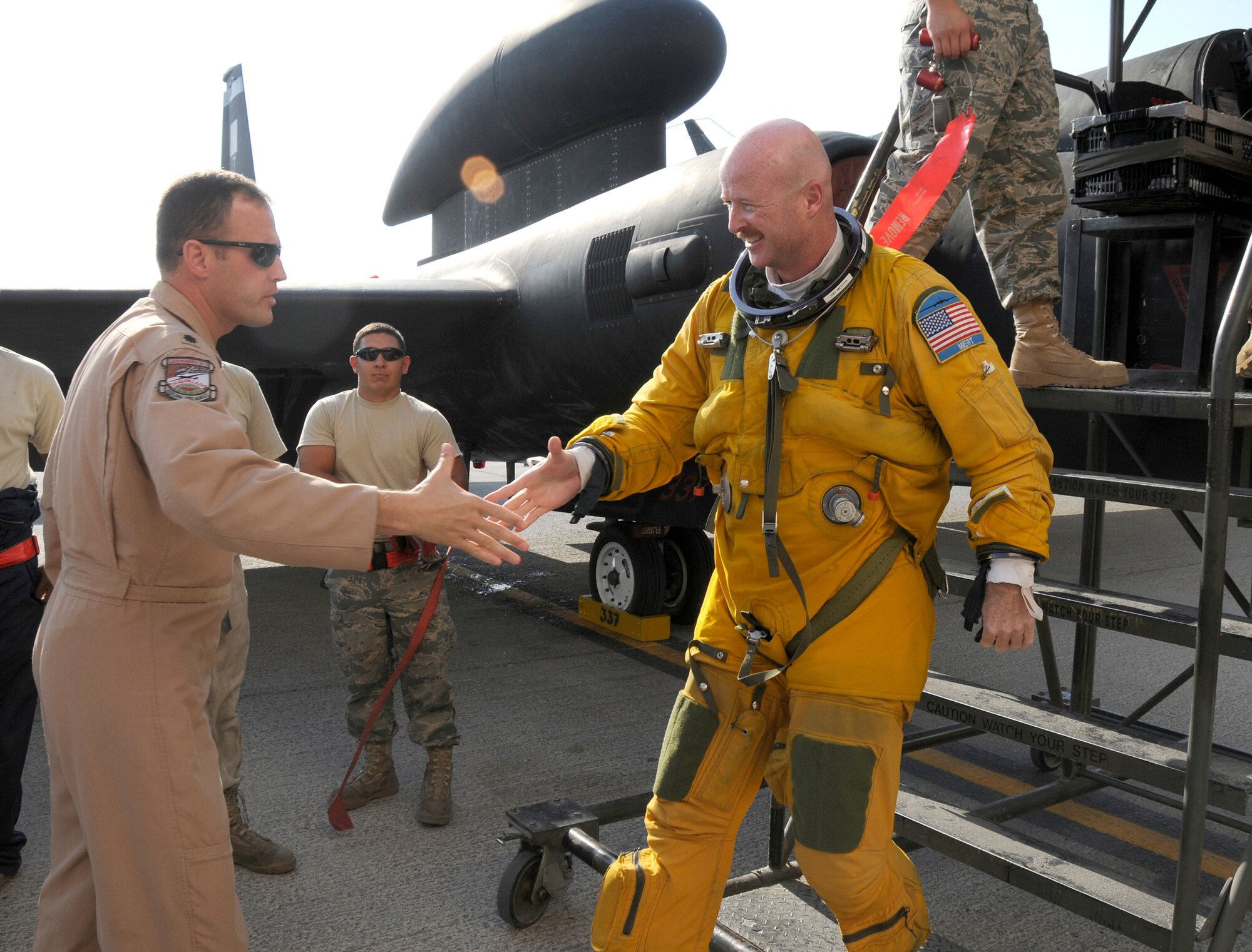 SOUTHWEST ASIA -- SOUTHWEST ASIA --  Maj. John Merten, a member of the 99th Expeditionary Reconnaissance Squadron, is congratulated  by Lt. Col. Vincent Catich on a successful mission and surpassing 1,000 hours flying in a U-2 Dragonlady. He is deployed from the 1st RS out of Beale Air Force Base, Calif., his hometown is Boulder, Colo.(U.S. Air Force photo/Tech. Sgt. Christopher A Campbell)(released)