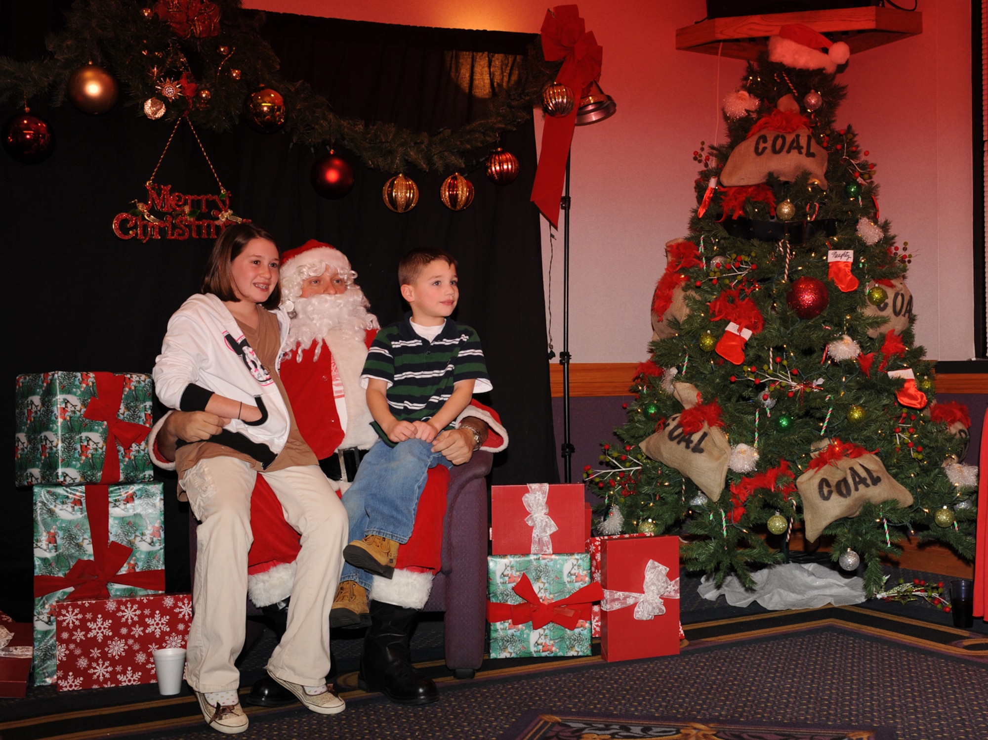WHITEMAN AIR FORCE BASE, Mo. - Children visit with Santa at the Mission's End Dec. 2. Santa arrived following the Christmas Tree lighting ceremony ridign a firetruck with police escort. (U.S. Air Force photo/Airman 1st Class Carlin Leslie)
