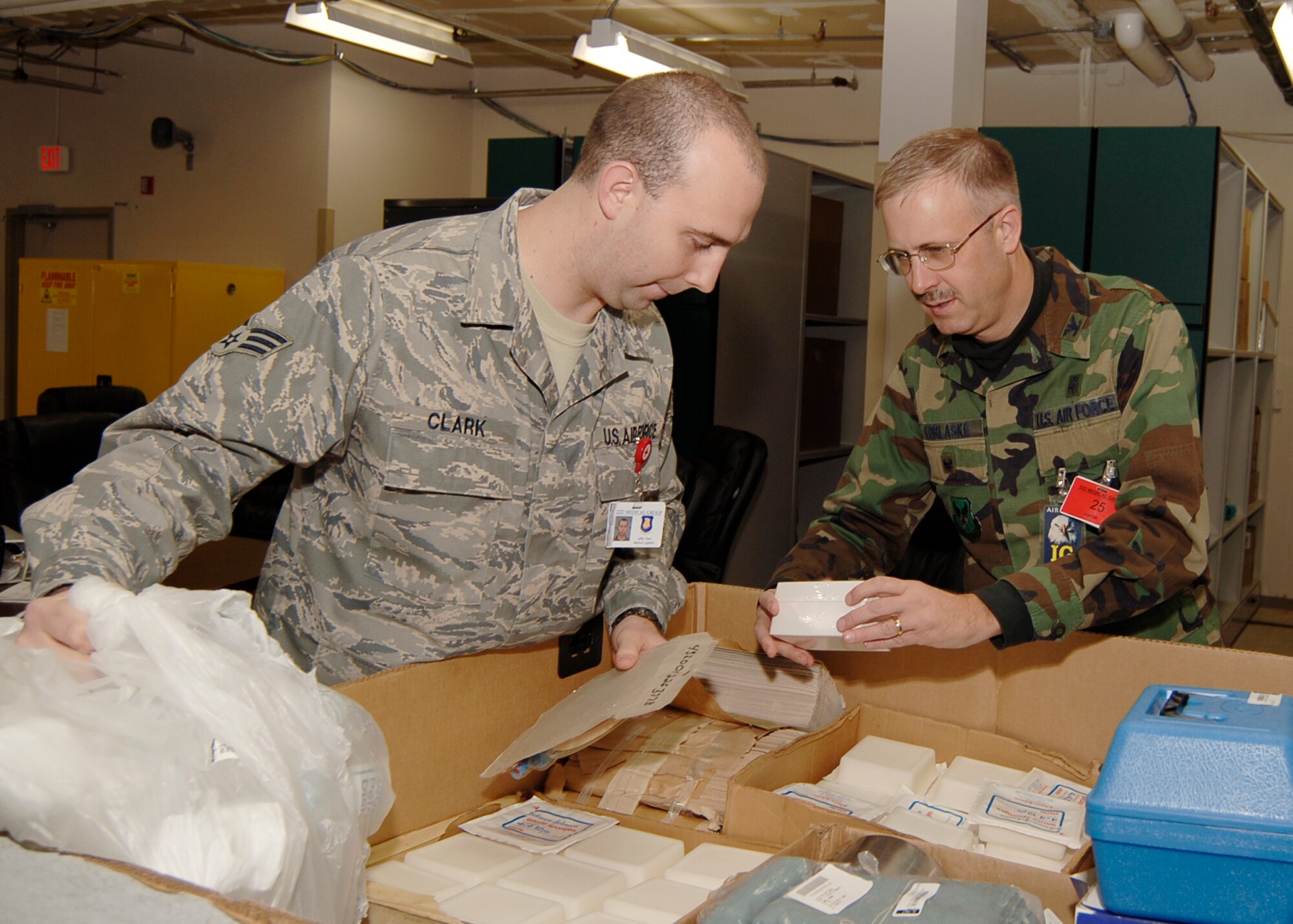 MCCONNELL AIR FORCE BASE, Kan. -- Col. John Korlaske, a health services inspection team member from Lackland Air Force Base, Texas, and Senior Airman Jeff Clark, 22nd Medical Support Squadron, review war-reserve medical supplies in a medical warehouse at McConnell Nov. 20. The HIS team inspected McConnell’s medical clinic Nov. 17 to 21.(Photo by Airman 1st Class Maria Ruiz)