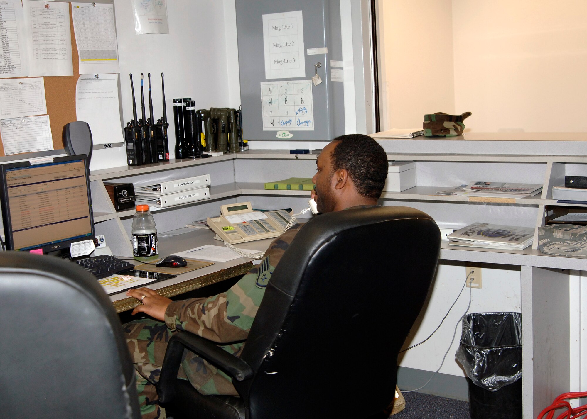 Staff Sgt. Rashsaan Truett, 22nd Logistics Readiness Squadron, receives a phone call for a government vehicle request, Nov. 14. Most requests start with a phone call at the vehicle dispatch office to ensure the required vehicle is available.  (Photo by Senior Airman Anthony Mejia)