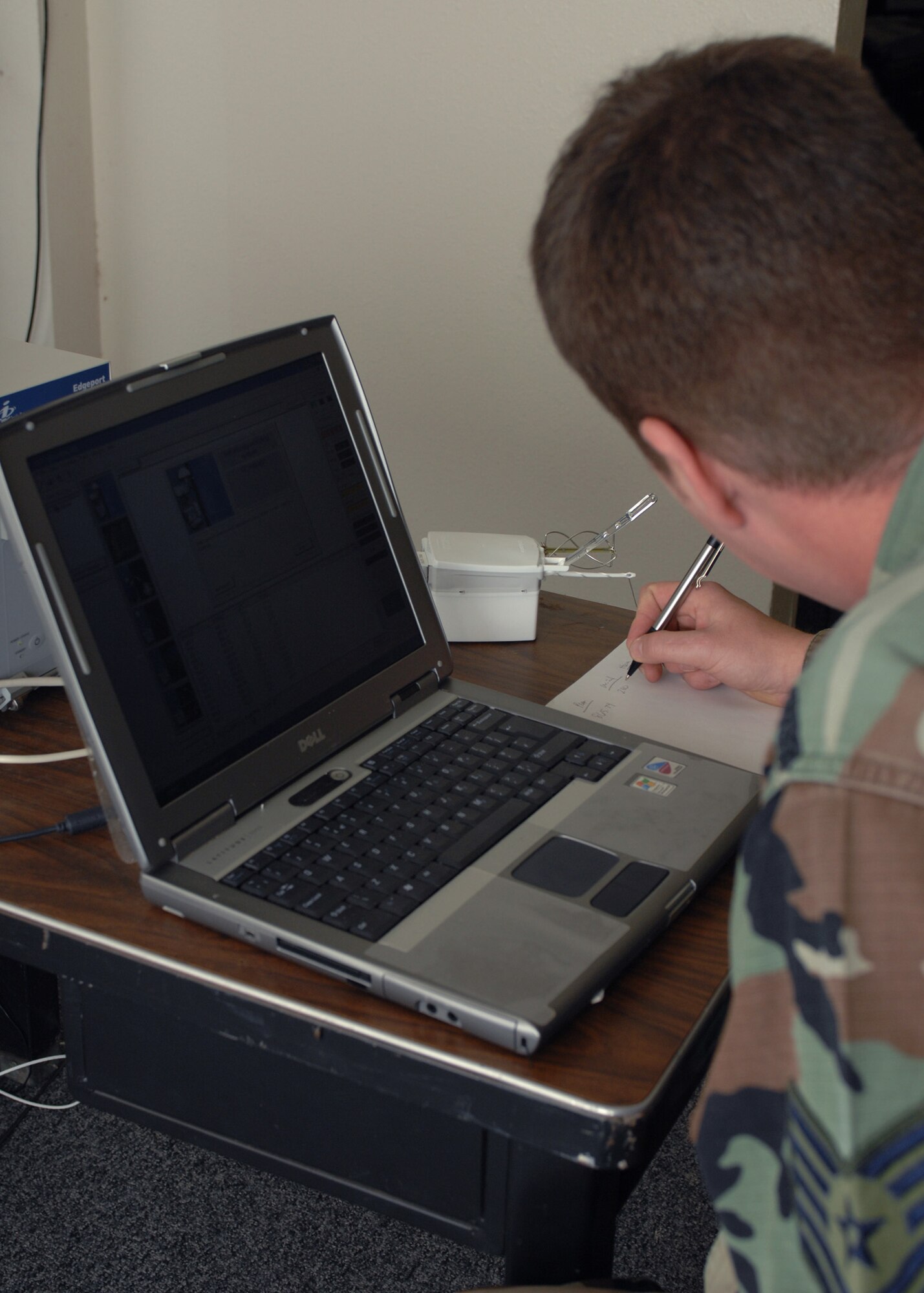 CANNON AIR FORCE BASE, N.M. -- Tech. Sgt. Adam Bolen, 27th Special Operations Support Squadron, writes down wind speed, altitude, and other important information given by the Radiosonde weather device attached to a weather balloon. Radiosondes can travel as distant as El Paso, Texas, or into distant parts of Texas.  (U.S. Air Force photo by Airman 1st Class James R. Bell) 