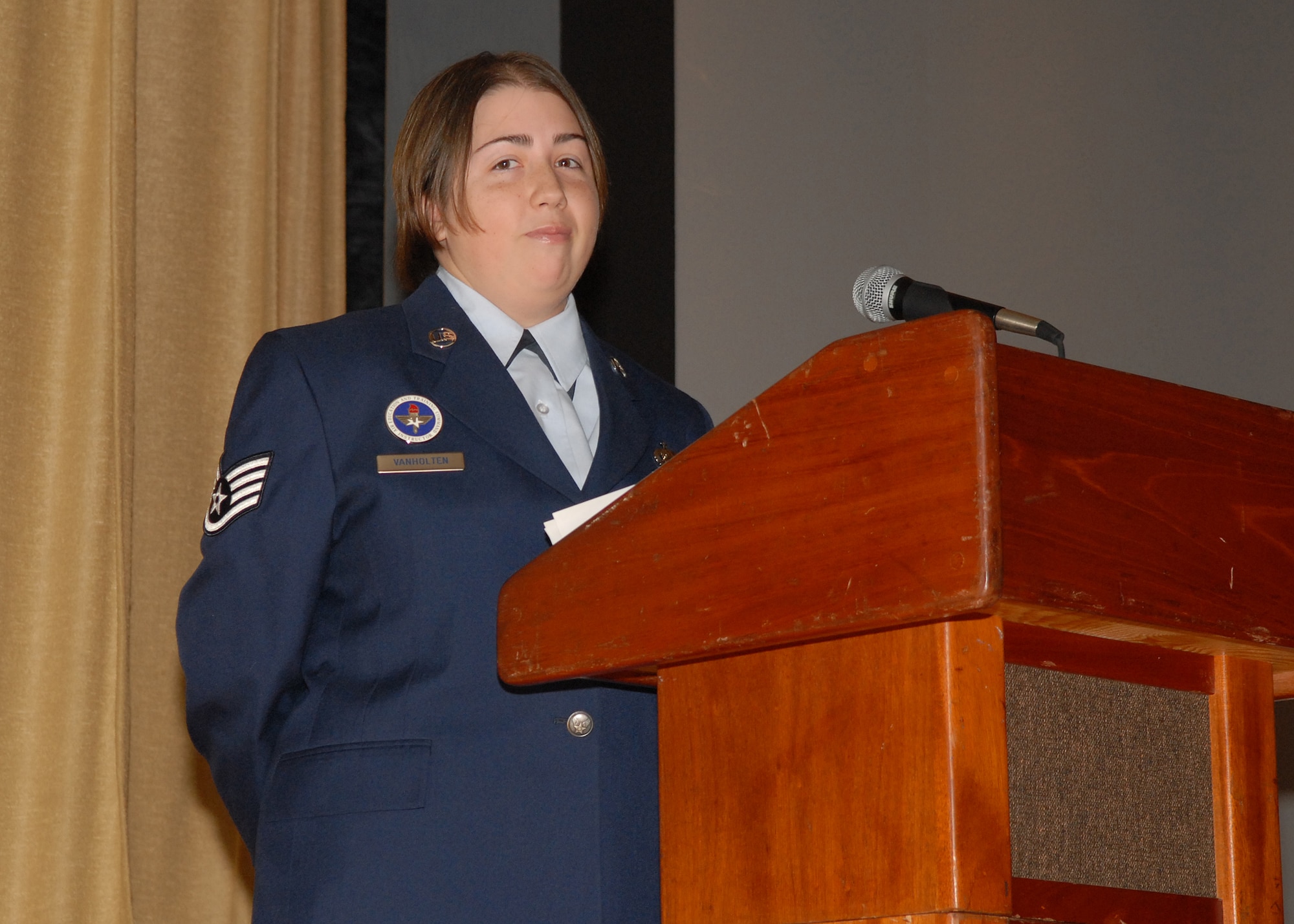 Staff Sgt. Elizabeth Van Holten, 316th Training Squadron instructor, serves as emcee at the graduation ceremony for Electronic Systems Security Assessment Apprentice Course class number 081007 on Dec. 2.  This marked the final Electronic Systems Security Assessment Apprentice class that will come through Goodfellow as the career field will soon merge with another intelligence career field, Intelligence Operations.  (U.S. Air Force photo by Senior Airman Kasabyan D. Musal).