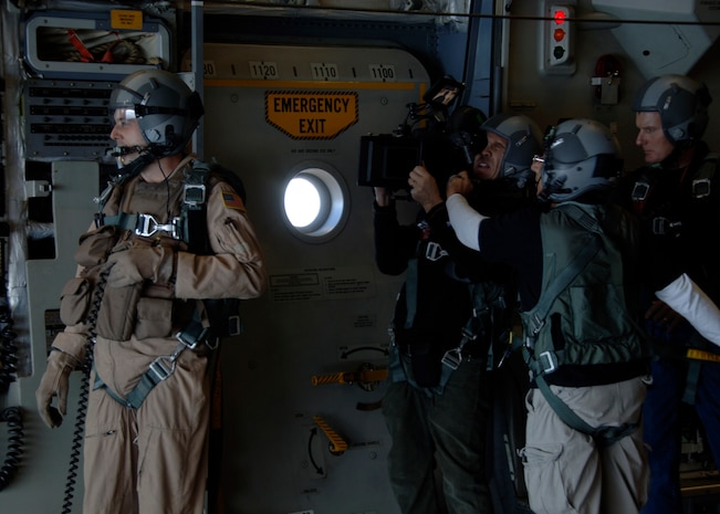 Staff Sgt. Steven Gore waits on the pilot's cue for when the C-17 is over the drop zone at Charleston AFB's North Auxiliary Field while a contracted camera crew films for the upcoming movie "Dear John" Nov. 26. The crew filmed several scenes for the movie in flight, on the flight line and in a Charleston AFB hangar. Sergeant Gore is a loadmaster with the 16th Airlift Squadron. (U.S. Air Force photo/Senior Airman Timothy Taylor)