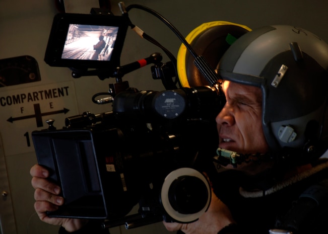 Richard Davidson films Staff Sgt. Steven Gore operating a C-17's rear door while in flight over Charleston AFB's North Auxiliary Field Nov. 26. The crew filmed several scenes for the movie in flight, on the flight line and in a Charleston AFB hangar. Mr. Davidson is a contracted cameraman for the upcoming film "Dear John" and Sergeant Gore is a loadmaster with the 16th Airlift Squadron. (U.S. Air Force photo/Senior Airman Timothy Taylor)