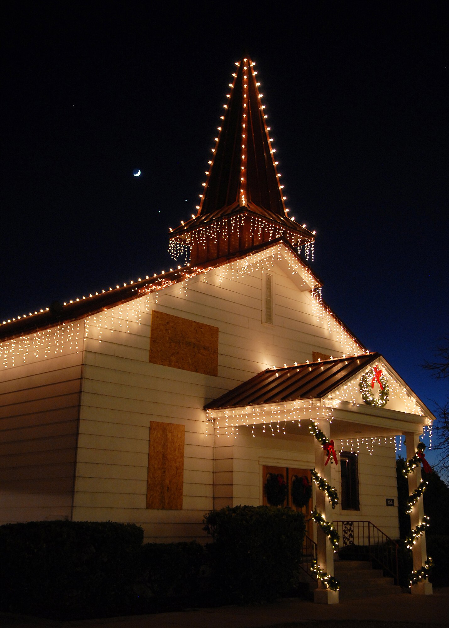 The old base chapel stands illuminated after the annual Goodfellow Air Force Base chapel and tree lighting ceremony on Dec. 1.  This marked the final year that lighting the old chapel would be part of the ceremony as it is due to be demolished in the coming months as chapel services move into a newly constructed building. (U.S. Air Force photo by Senior Airman Kasabyan Musal).