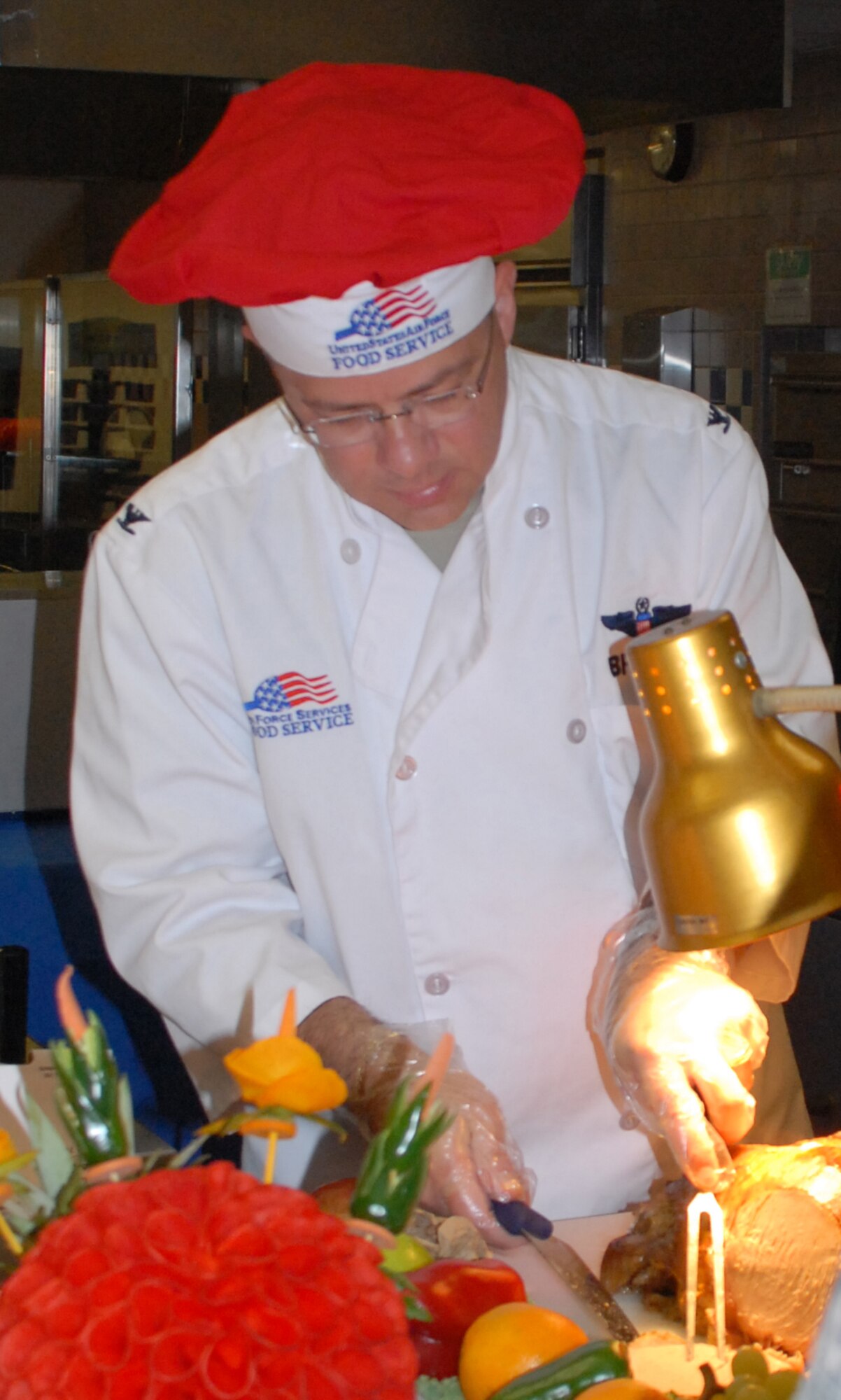 Col. Randal Bright, 512th Airlift Wing commander, carves the turkey for the Thanksgiving feast at the Patterson Dining Facility Nov. 28.  (U.S. Air Force photo/Staff Sgt. Chad Padgett)