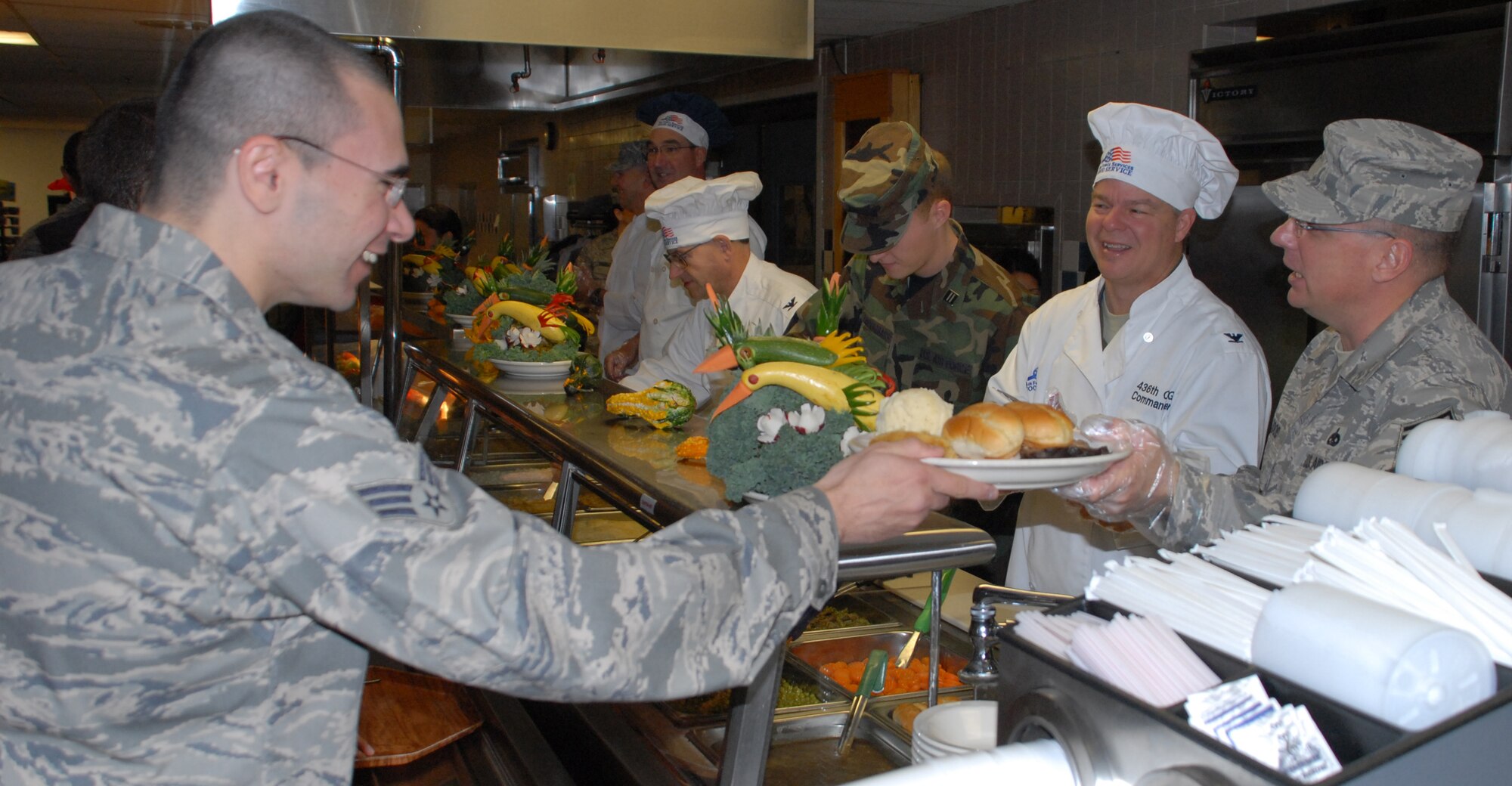 Chief Master Sgt. John Wood, 436th Airlift Wing command chief, serves food to Team Dover Airmen at the Patterson Dining Facility Nov. 28.  Chief Wood, along with other members of the 436th and 512th AW leadership, volunteered their time to serve the Thanksgiving feast.  (U.S. Air Force photo/Staff Sgt. Chad Padgett)