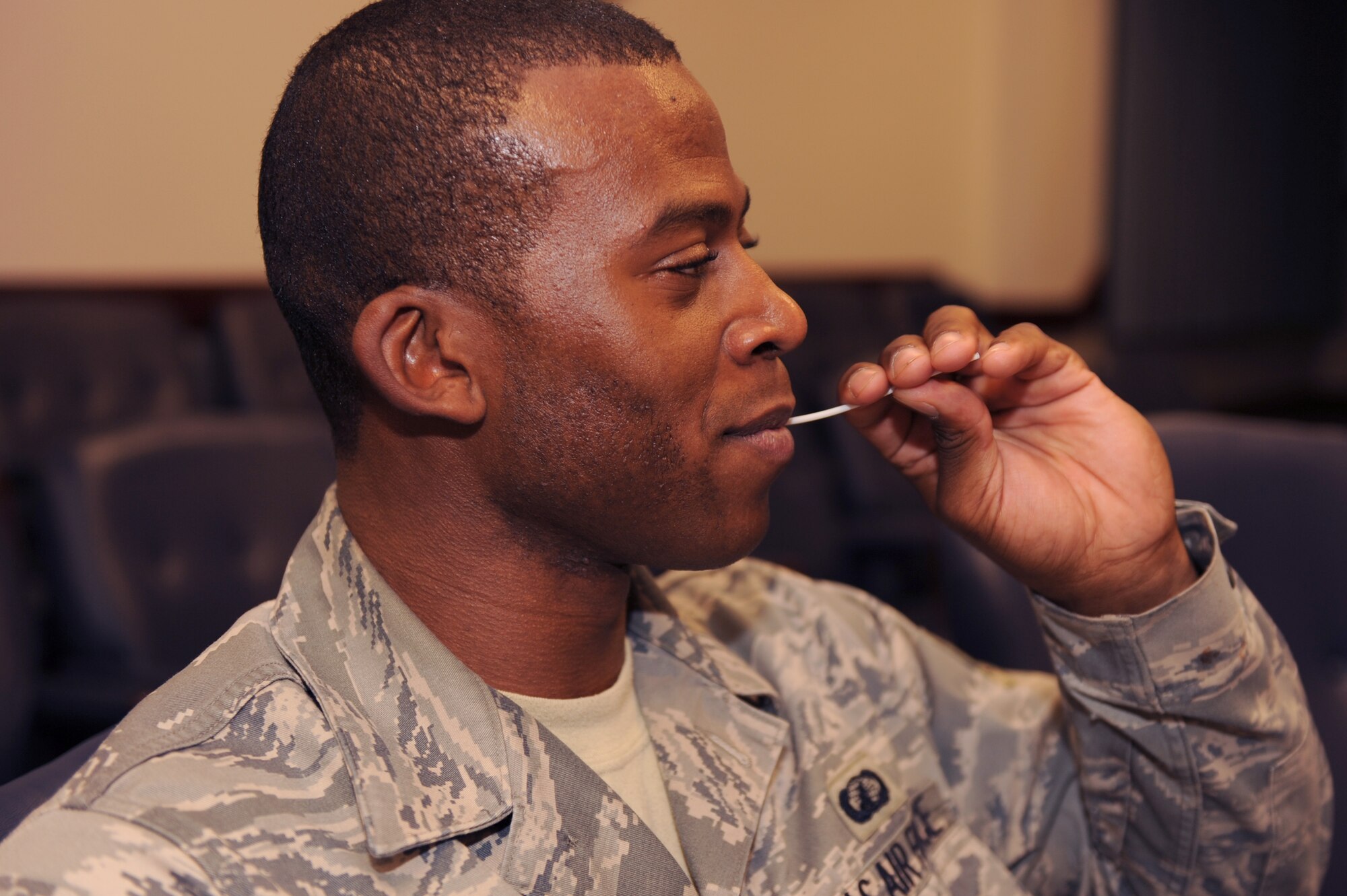 Senior Airmen Derrick Mydell, 99th Comptroller Squadron special actions technician, collects a cotton swab sample from the inside of his cheek in a bone marrow registration drive held on Nellis Air Force Base, Nev., December 2, 2008. From Dec. 1-12, Team Nellis is holding the 2008 DoD Bone Marrow Program Registration Drive, registering eligible military identification card holders, including active-duty service members and their spouses, civil service, guard, reserve and Coast Guard.