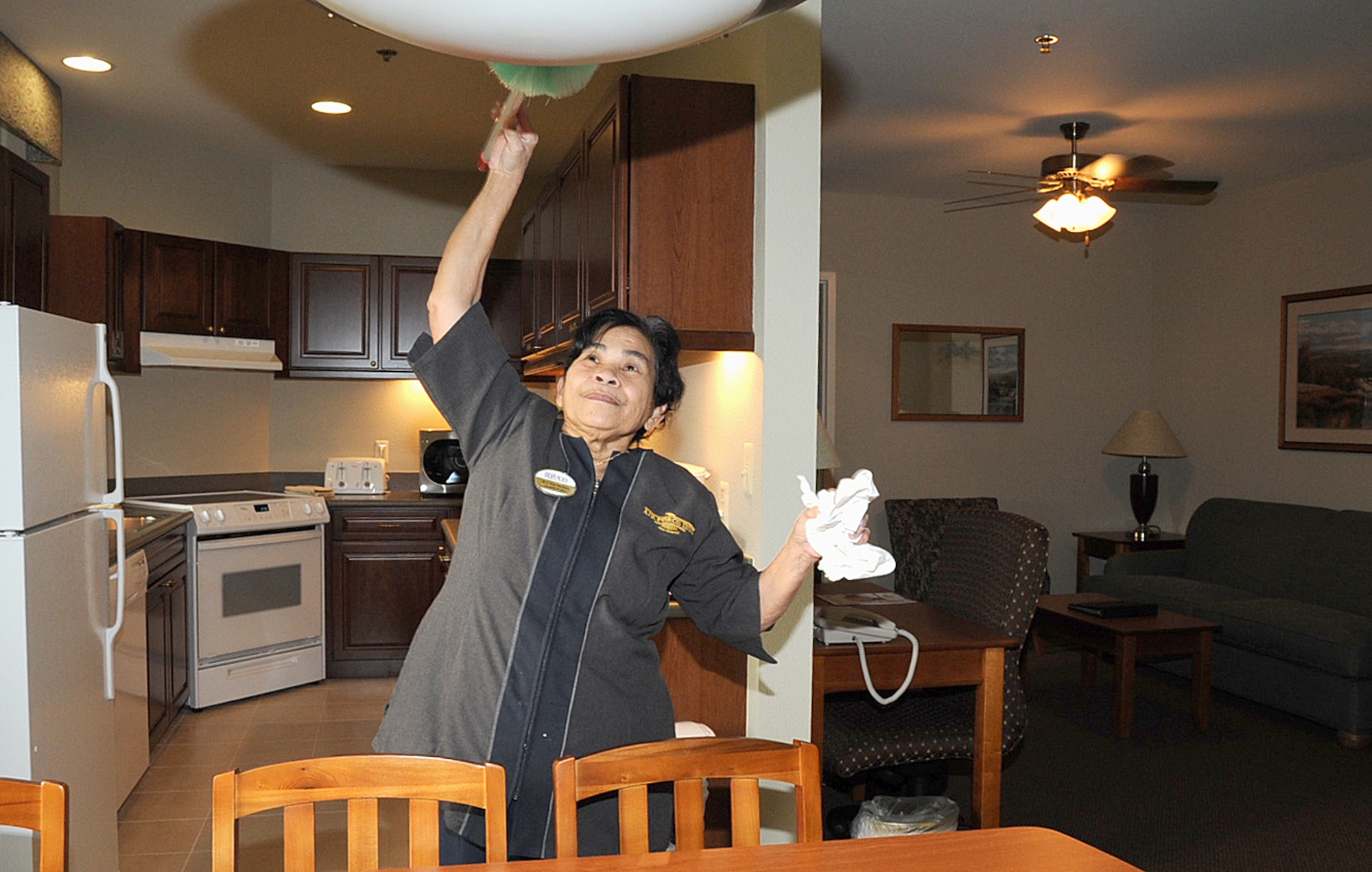 Amy Abedejos, 305th Services Squadron All American Inn housekeeper, cleans a two-bedroom unit at the new temporary living facility here. The new lodging facility contains 50 units for families, all of which feature full kitchens, washer and dryer, and high-speed internet. The new facility is set to officially open with a ribbon-cutting ceremony Dec. 5. (U.S. Air Force photo/Staff Sgt. Danielle Johnson)