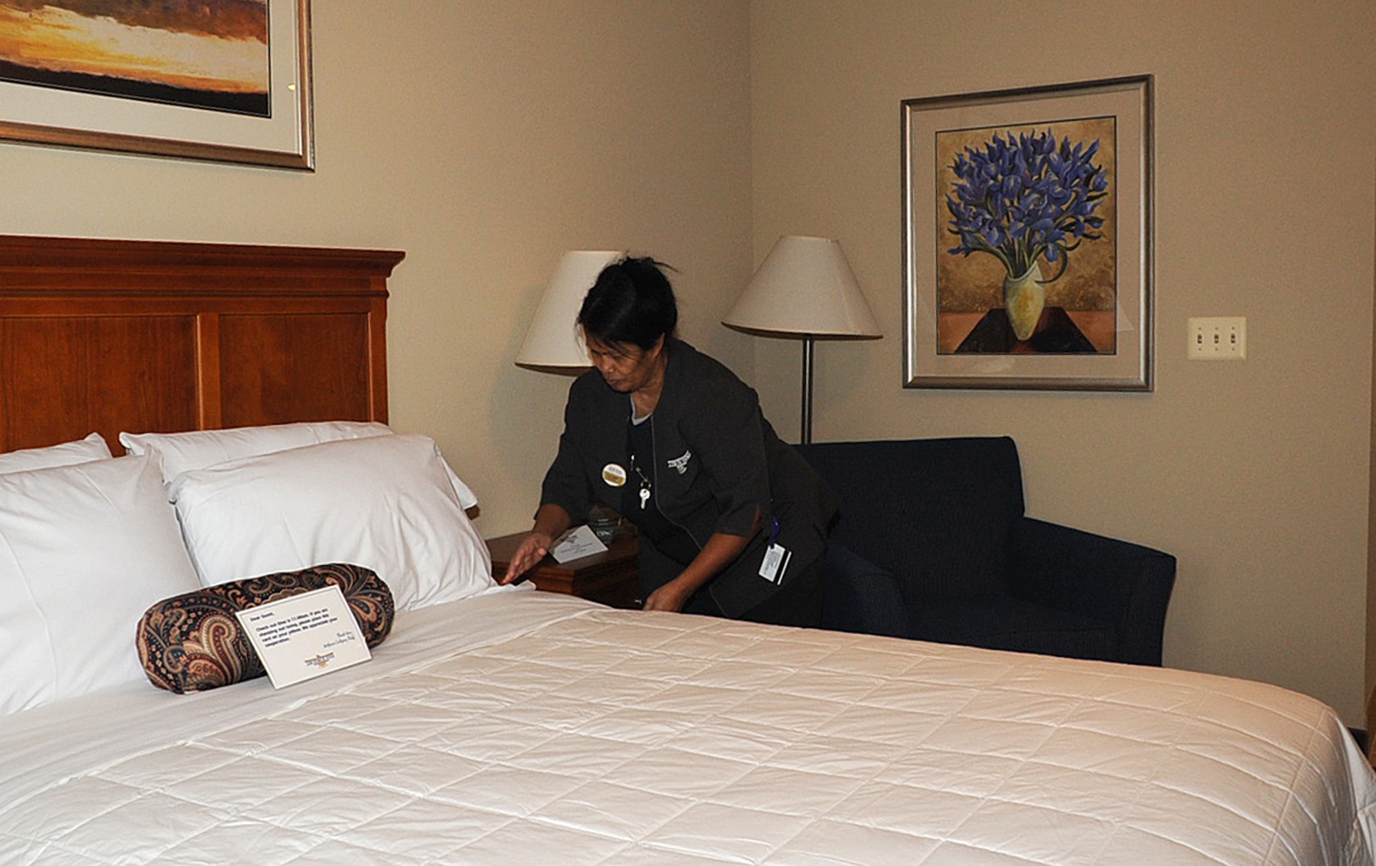 Urai Campbell, 305th Services Squadron All American Inn housekeeper, tidies a bed in  the new lodging facilities here. The rooms in the new facility will feature high-speed internet access and flat-panel TVs. The lobby also offers a cafe, business center with computers, printers and fax machines and a fitness center. (U.S. Air Force photo/Staff Sgt. Danielle Johnson)
